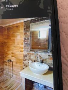 a bathroom with a sink and a mirror at VILLA MAKRI 2 in Makri