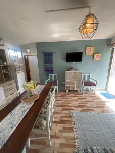 a living room with a table and chairs and a television at Rancho Elquino in Vicuña