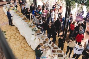 a crowd of people standing around a long table with food at Complex Turistic Le Baron Vatra Dornei in Vatra Dornei +107 photos
