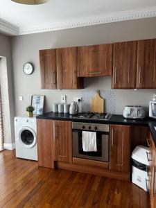 a kitchen with wooden cabinets and a stove top oven at Carraig House in Cavan