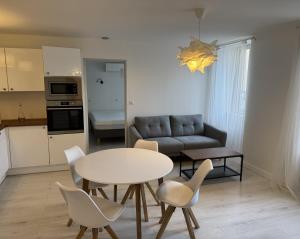 a kitchen and a living room with a table and chairs at 10 rue Carnot in Montceau-les-Mines
