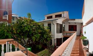 a white house with a staircase leading to it at Spanish Friends in Sucre +50 photos