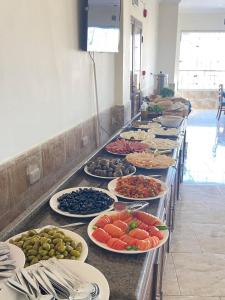 a buffet line with plates of different types of food at Jadara view in Irbid