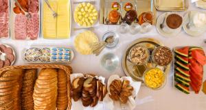 a table with many different types of breads and other foods at Ametiszt Hotel Harkány in Harkány +44 photos