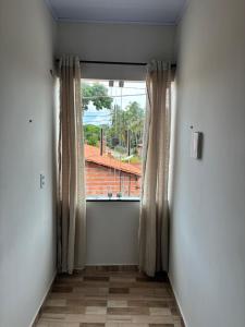 a window with curtains in a room with a view at Lardunas in Santo Amaro +1 photo
