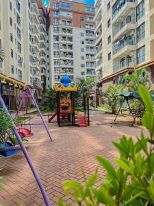 a playground with a play equipment in a city at Spacious 3-bedroom apartment in Nairobi close to the Airport and SGR Terminus in Machakos