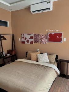 a bedroom with a bed and a air conditioner on the wall at Rémi Homestay in Thôn Văn Dương