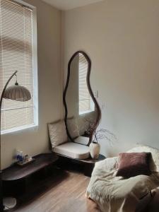 a bedroom with a large mirror and a bed at Rémi Homestay in Thôn Văn Dương