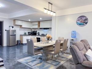 a kitchen and dining room with a table and chairs at Spacious 3-bedroom apartment in Nairobi close to the Airport and SGR Terminus in Machakos