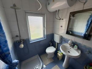 a bathroom with a sink and a toilet and a mirror at GRANDPA's HOME in Pusteci +28 photos
