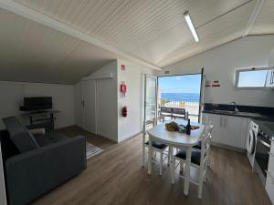 a kitchen and living room with a table and a couch at Madalena House in Madalena do Mar +78 photos