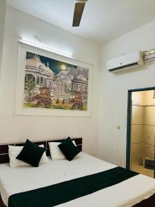 a bedroom with a bed with a painting on the wall at Hotel park view in Bathinda
