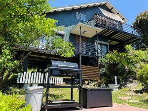 a house with a grill in front of it at good wind 野風楼 in Yawatano