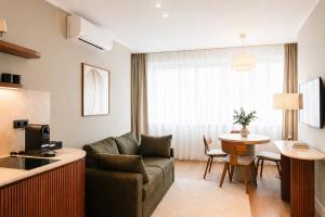 a living room with a couch and a table at HeyMi Apartments Brick Lane Vienna in Vienna