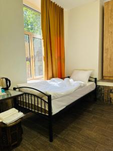 a bed sitting in a room with a window at Mini hotel in centre in Yerevan