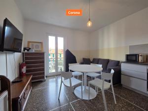 a kitchen and a living room with a table and chairs at Principe - By Turent in Pietra Ligure