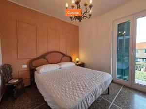 a bedroom with a bed and a chandelier at Principe - By Turent in Pietra Ligure +14 photos