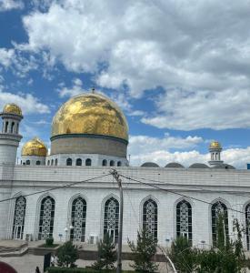 a building with a gold dome on top of it at Apartament27 in Almaty