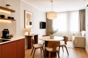 a kitchen and living room with a table and chairs at HeyMi Apartments Brick Lane Vienna in Vienna +124 photos