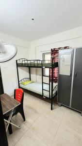 two bunk beds in a room with a table and a chair at Alpine Hostel Services in Pune +6 photos