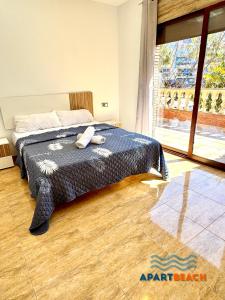 a bedroom with a bed and a large window at APARTBEACH BLAU MAR y PORT AVENTURA in Salou +74 photos