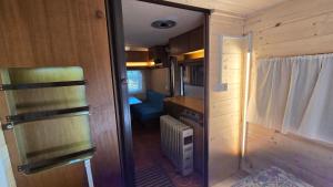 an interior view of a small kitchen in a tiny house at Camping Yoghi e Bubu in San Giacomo +60 photos