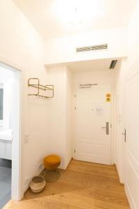 a room with a white door and a stool at MINTNaschmarkt in Vienna +177 photos