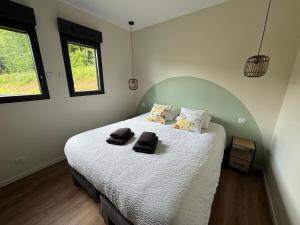 a bedroom with a bed with two towels on it at L'Orée Lodge in Montcornet +27 photos