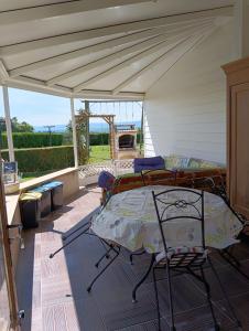 a patio with a bed and a canopy at Gite Belle vue in Semur-en-Brionnais