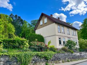 a house with a fence in front of it at Apartments am Burgberg in Bad Harzburg