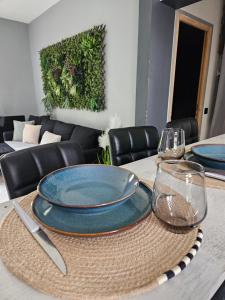 a table with plates and wine glasses on it at Maison du Château d'eau Proche Disney, Parc Astérix, CDG, Paris, Parc des exposition in Mitry-Mory