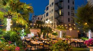 an outdoor event with tables and chairs and lights at Xanh Tốt Hotel - FLC Sầm Sơn in Sầm Sơn