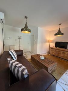 a living room with a couch and a coffee table at Effealatapartments - L'Oasi del Forte in Forte dei Marmi