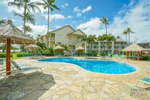 a resort swimming pool with chairs and umbrellas at Garden Studio | Free Wi-Fi | No Resort Fees in Kapaa