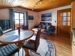 a living room with a table and a couch at Ferienwohnung Soiernblick Krün Bärnbichl in Krün