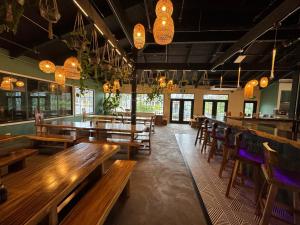 a restaurant with wooden tables and chairs and lights at Garden Studio | Free Wi-Fi | No Resort Fees in Kapaa