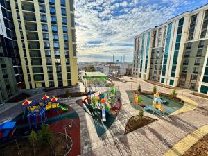 an aerial view of a playground in a city at A-Six Apartment, ЖК Достар 26 in Karagandy