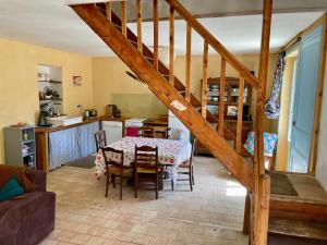 a kitchen and dining room with a table and a staircase at Ecurie Piaffe & Cie in Lurais