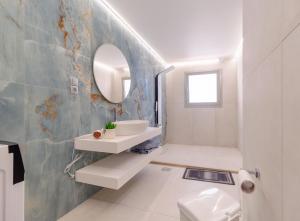 a bathroom with a sink and a mirror at Pension Alexandros in Preveza +45 photos