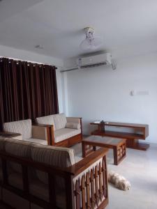 a living room with two couches and a table at Be Cool in Aturugiriya