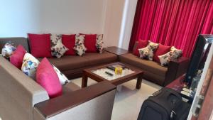 a living room with two couches and a tv at Be Cool in Aturugiriya