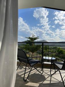 a balcony with chairs and a view of the ocean at AMAD Aparthotel in Sarandë