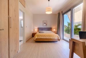 a bedroom with a bed and a large window at Pension Alexandros in Preveza