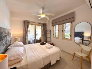 a bedroom with a bed and a mirror and a chair at Olive Apartment in Tala +38 photos