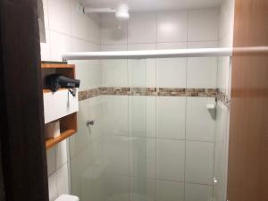 a bathroom with a shower with a glass door at Flats Olinda Vista Mar in Olinda +24 photos