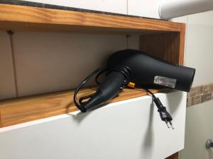 a blow dryer on a shelf in a room at Flats Olinda Vista Mar in Olinda