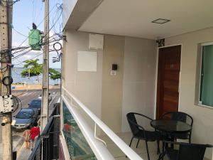 a balcony with a table and a view of a street at Flats Olinda Vista Mar in Olinda
