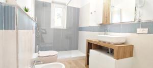 a bathroom with a sink and a toilet and a shower at Bellagio in Castelsardo +35 photos