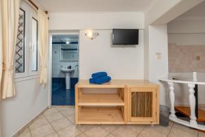a room with a table and a sink and a table at Villa by Hotel Thira in Fira