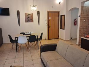 a living room with a couch and a table and chairs at TAKIS HOUSE in Káto Panayía